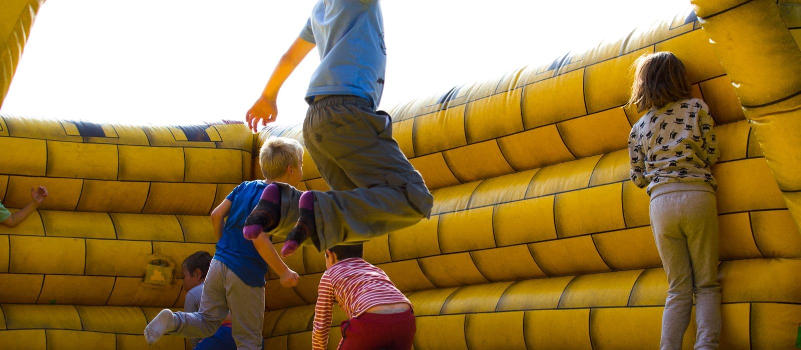 Kids jumping in a colourful bounce house